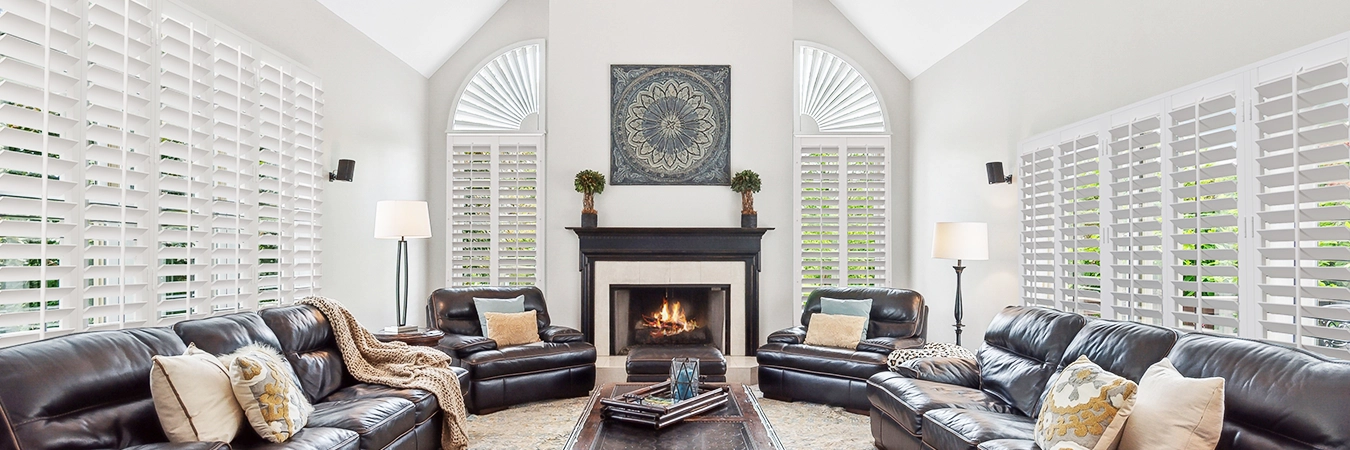 White Polywood shutters on three walls of living room windows