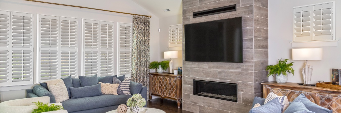 Plantation shutters in St. Marys family room with fireplace