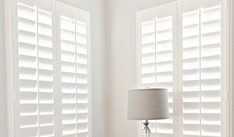 Plantation shutters can be found in a multitude of neutral whites and wood stains. Plantation shutters in a corner window.