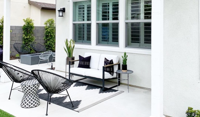 Spending a little time mulching and weeding can provide you with an outdoor oasis. Backyard with plantation shutters