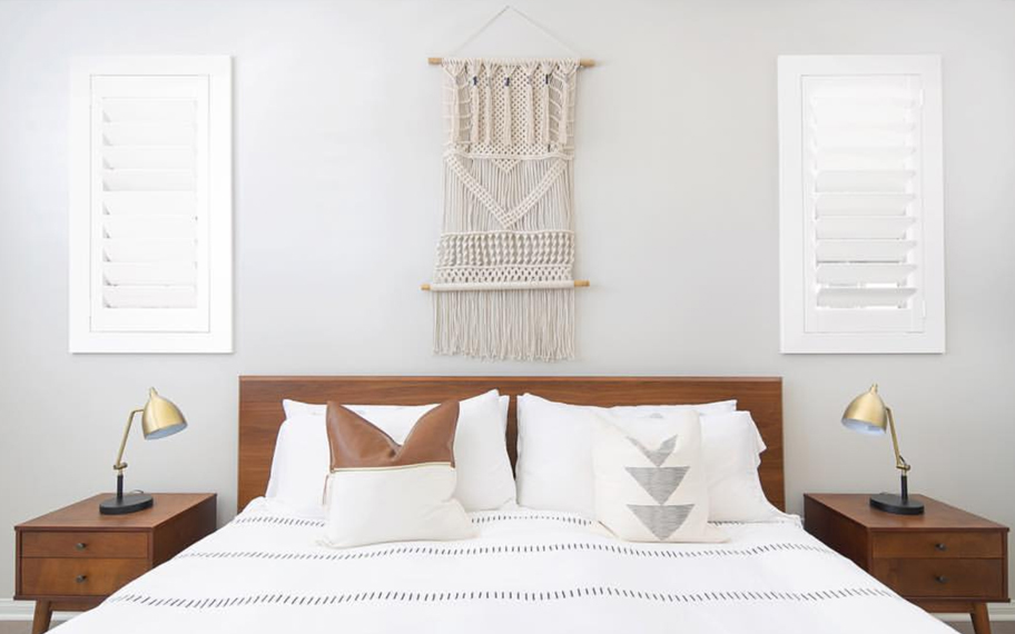 Custom-fitted louvered shutters provide excellent nighttime privacy in Jacksonville. Photo Credit: Audrey Crisp Louvered shutters in a bedroom.