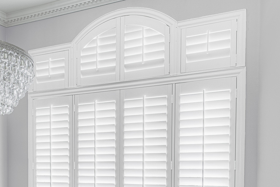 Customize your Palladian windows with white Polywood shutters in Jacksonville. White Polywood Palladian windows in a dining room.