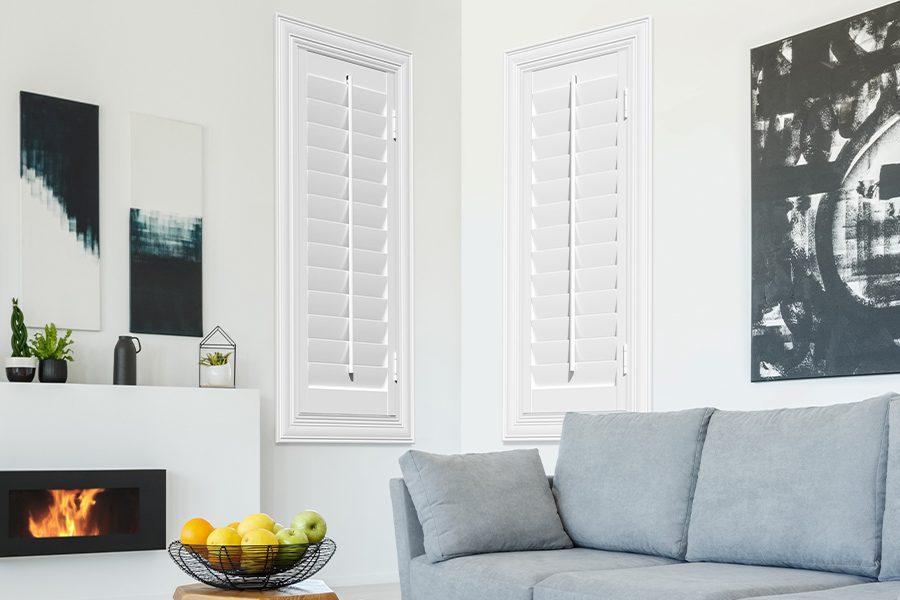 White polywood shutters in a corner of a modern living room.