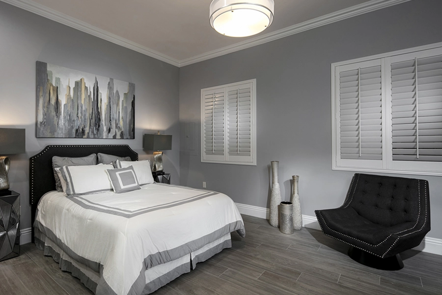 Close your custom Polywood shutters to beat the heat and keep your Jacksonville bedroom cool. White Polywood shutters on bedroom windows