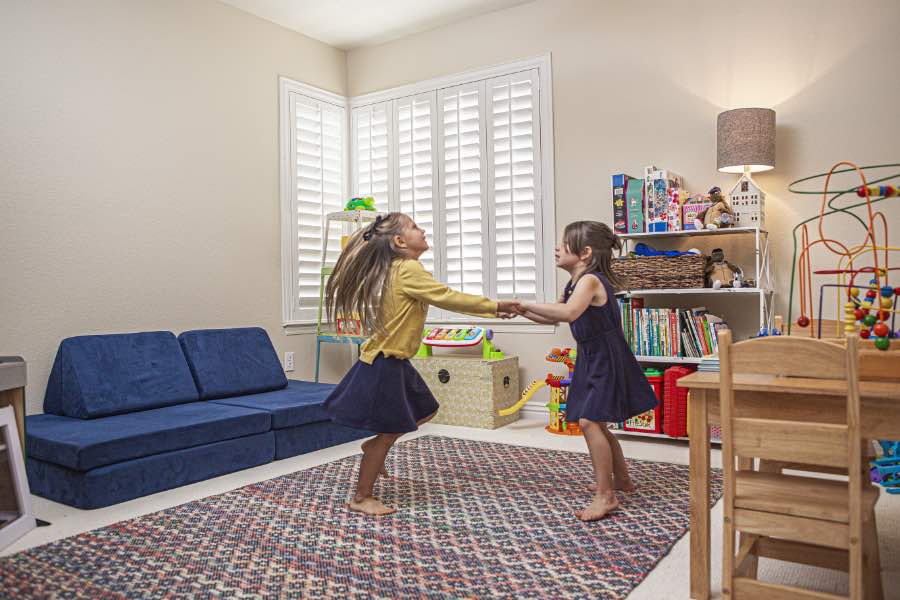 Choose Polywood shutters for durable, kid-friendly great room window treatments in Jacksonville. Polywood shutters on multiple windows in a sitting area