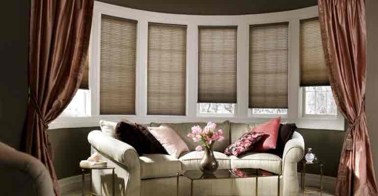 Adjustable honeycomb shades in parlour bow window.