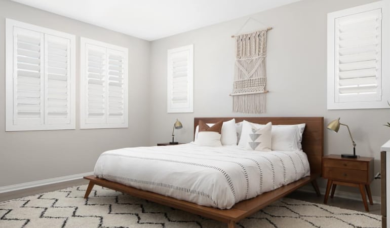 Open shutter louvers will help any Jacksonville room feel larger. Plantation shutters in a model home bedroom.