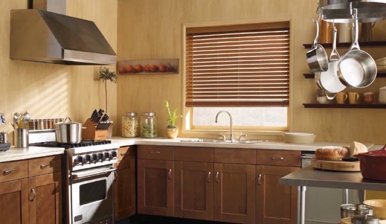 Faux wood blinds look amazing in Jacksonville kitchens. Jacksonville kitchen faux wood blinds.