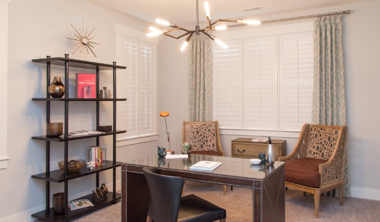 Picking the right window treatments can result in an increase in natural light. Jacksonville home office with plantation shutters.
