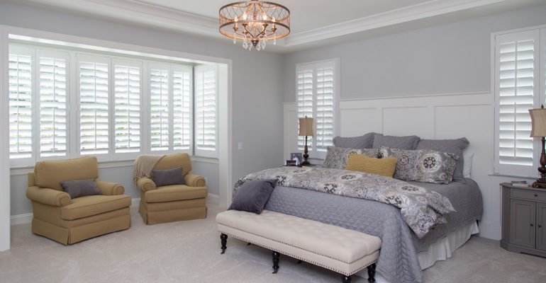 Indoor shutters offer subtle style. Plantation shutters in Jacksonville bedroom.