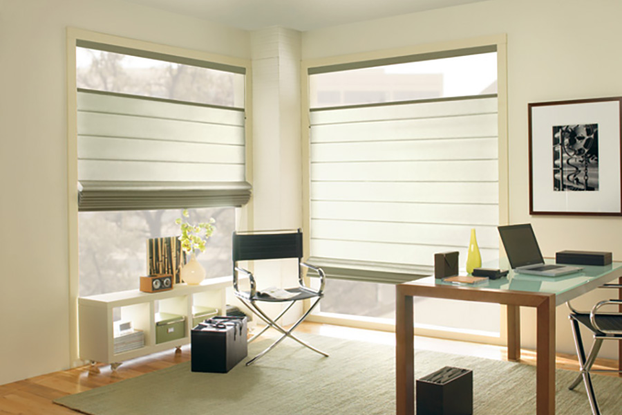 Roman shades come in multiple styles to fit your tastes and decor. White top-down/bottom-up Roman shades in a home office.
