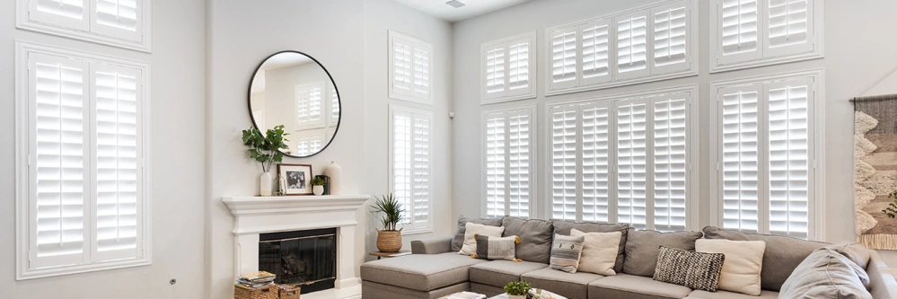 White Polywood shutters on windows in a white living room