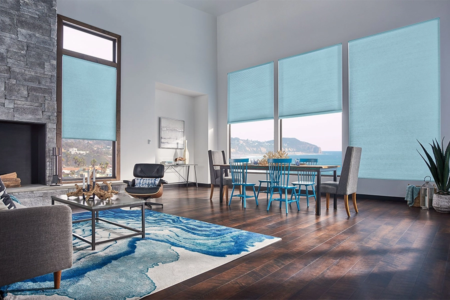 Smart motorized window shades are perfect on tall windows in your Jacksonville home. Blue motorized shades on tall living room windows