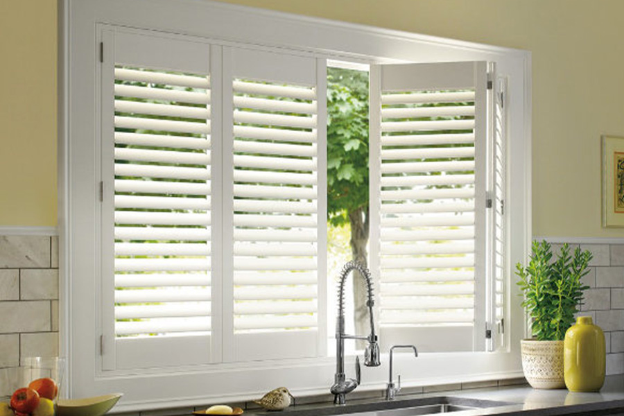 Polywood shutters are built to withstand the test of time in Jacksonville. White Polywood shutters above a kitchen sink.