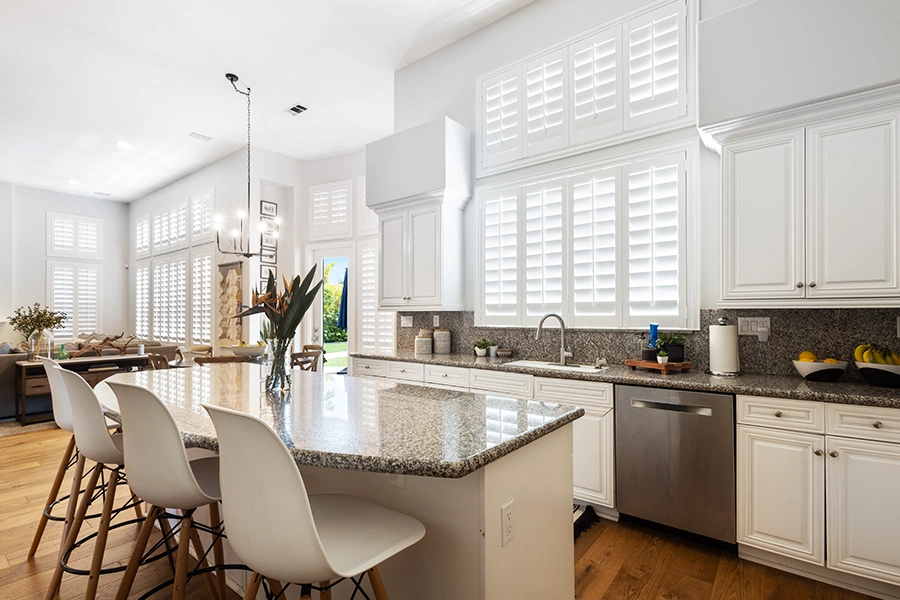 Call Sunburst Shutters Jacksonville today to discuss current sales and everything window treatments! White Polywood shutters on kitchen windows
